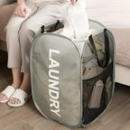 Cesto de lavanderia dobrável AirMesh Nomanni com estrutura firme e tecido ventilado, perfeito para manter roupas organizadas sem ocupar espaço.
