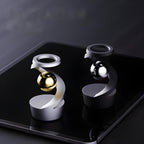 Escultura giroscópica decorativa com movimento contínuo, ideal para mesas de escritório e ambientes modernos.
